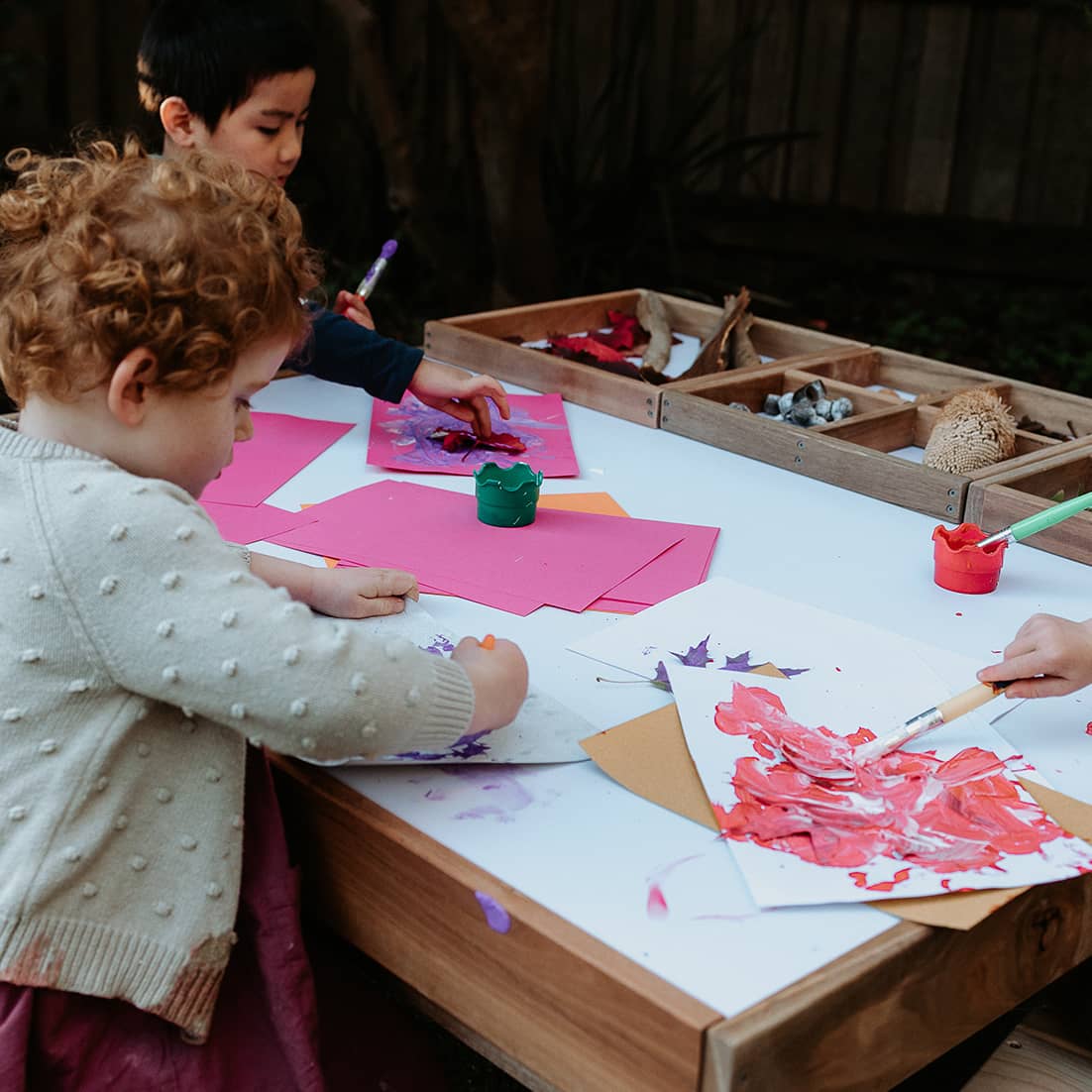 Kids sitting  and crafting at a hardwood multipurpose table