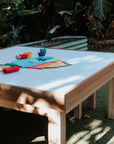 A timber arts and crafts table in an early learning centre yard