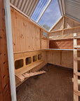 Bespoke Pine interior of a large barn style chicken coop with clear roof panels