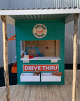 A colourful burger shop themed cubby house in an educational play area