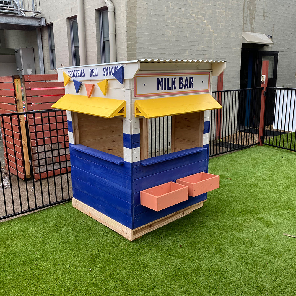 A retro styled milk bar cubby house in a pub club courtyard on astro turf