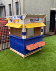 A retro styled milk bar cubby house in a pub club courtyard on astro turf