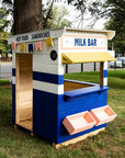 A retro styled milk bar cubby house in a park area