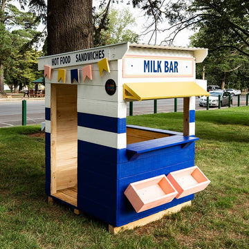 A retro styled milk bar cubby house in a park area