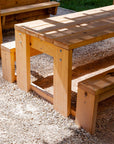 Detail shot of a Timber outdoor table and bench seat for education, set under a shade structure