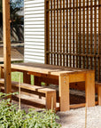 Timber outdoor table and bench seat education, set in a school garden with shade structure