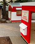 A cubby house village scene with post office and mailbox