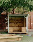 A painted wooden potting shed with storage boxes in a school playground