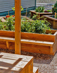 Raised timber garden bed with seating detail shot in sunny landscaped outdoor classroom