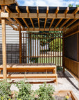 Timber outdoor pergola with benches and tables in bright sun