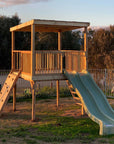 Raised platform cubby house with ladder and slides