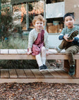 kids sitting on a wooden bench