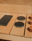 Image of the outdoor mud kitchen stovetop components including wooden oven knobs