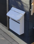 A painted toy letterbox on a wooden cubby house