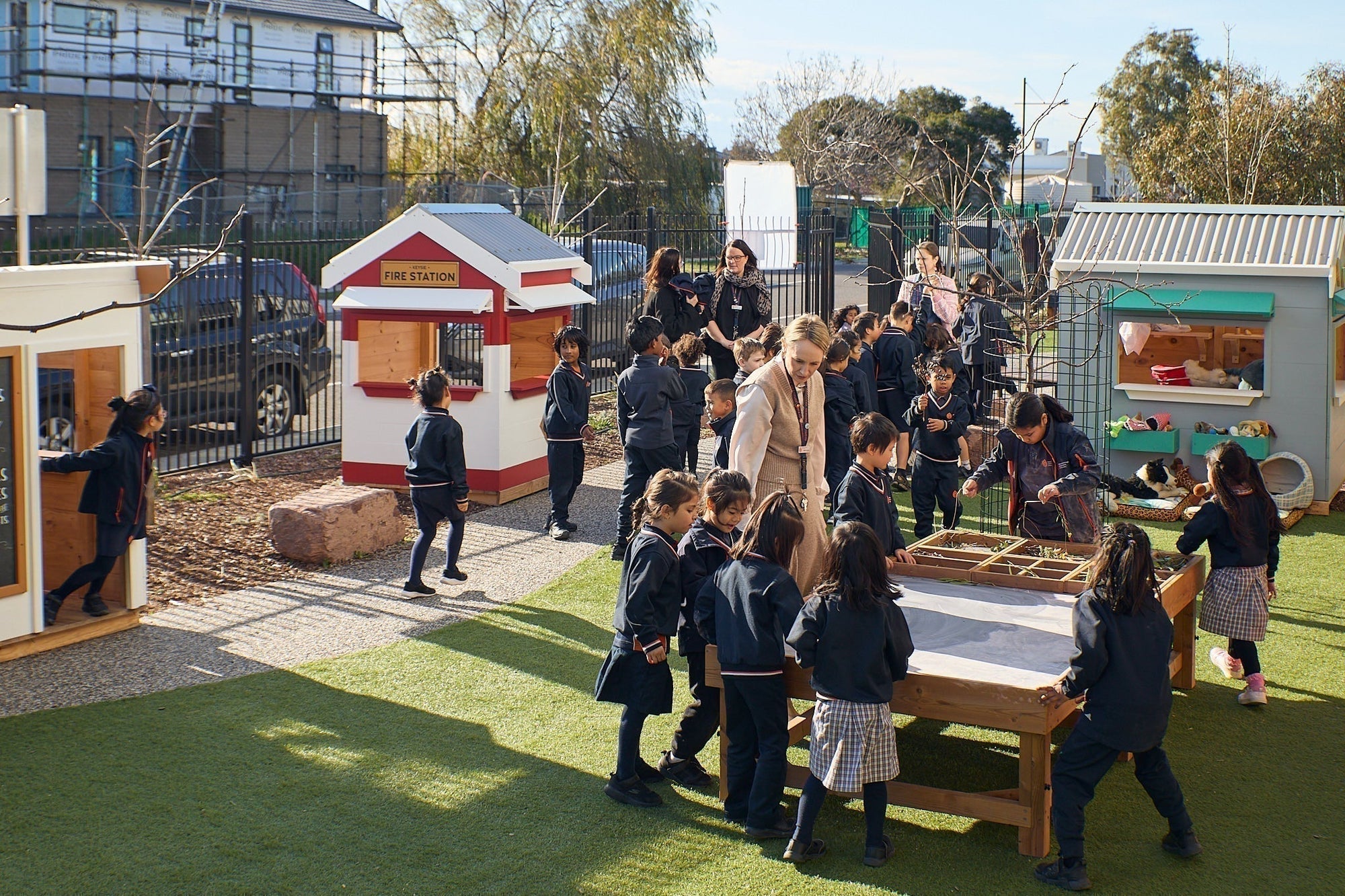 Primary School Kids playing outdoors in their imagination play village