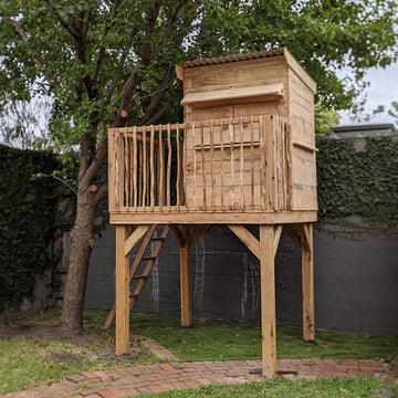A stunning natural timber treehouse with ladder and handrail
