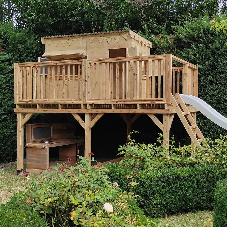 A cypress and pine timber raised cubby house with slide
