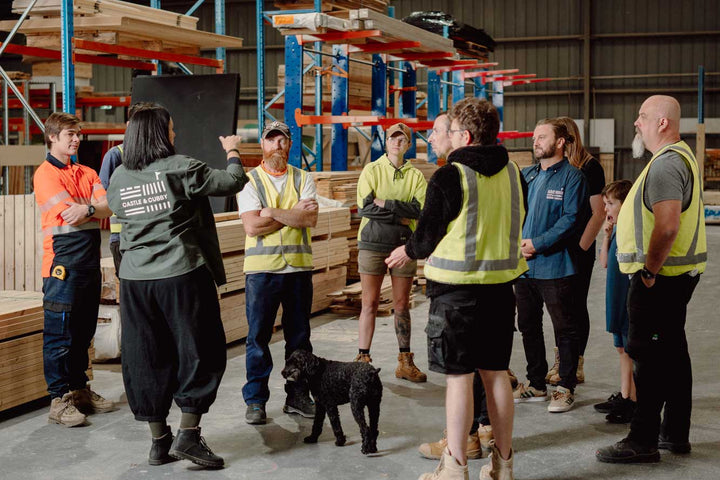 Image of Castle & Cubby team at their workshop where they make kids wooden cubby houses discussing their days work