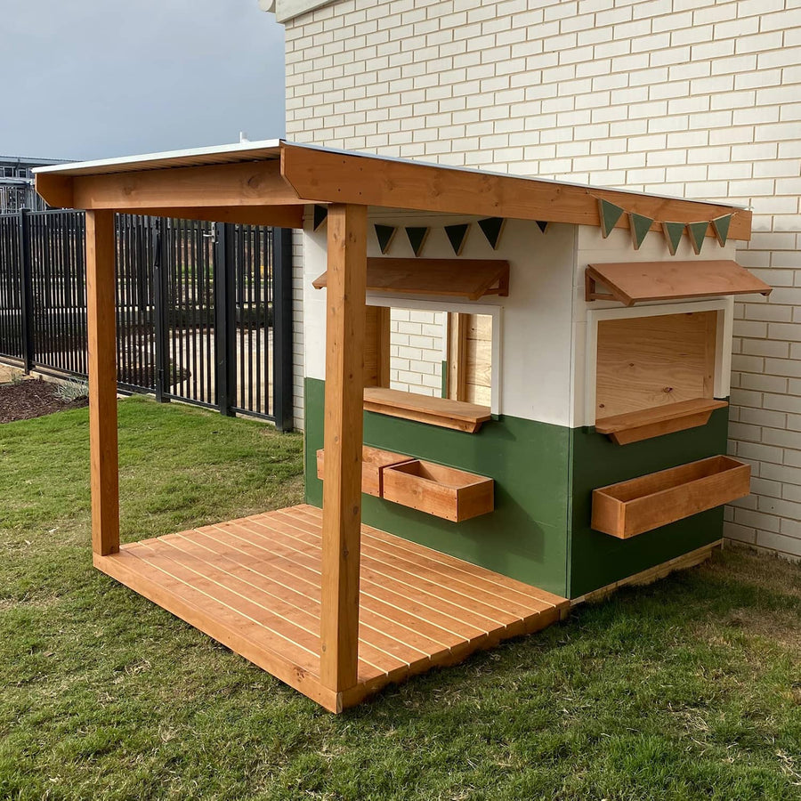A white and green wooden cubby house with front verandah education commercial grade