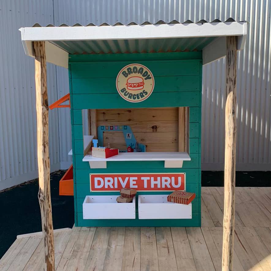 A colourful burger shop themed cubby house in an educational play area