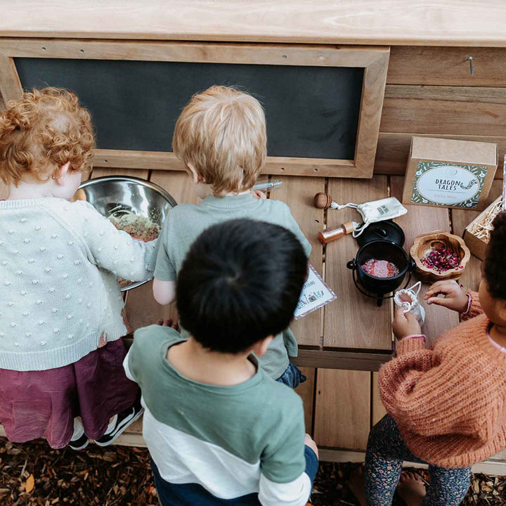 Kids playing at a Wooden Mud Kitchen