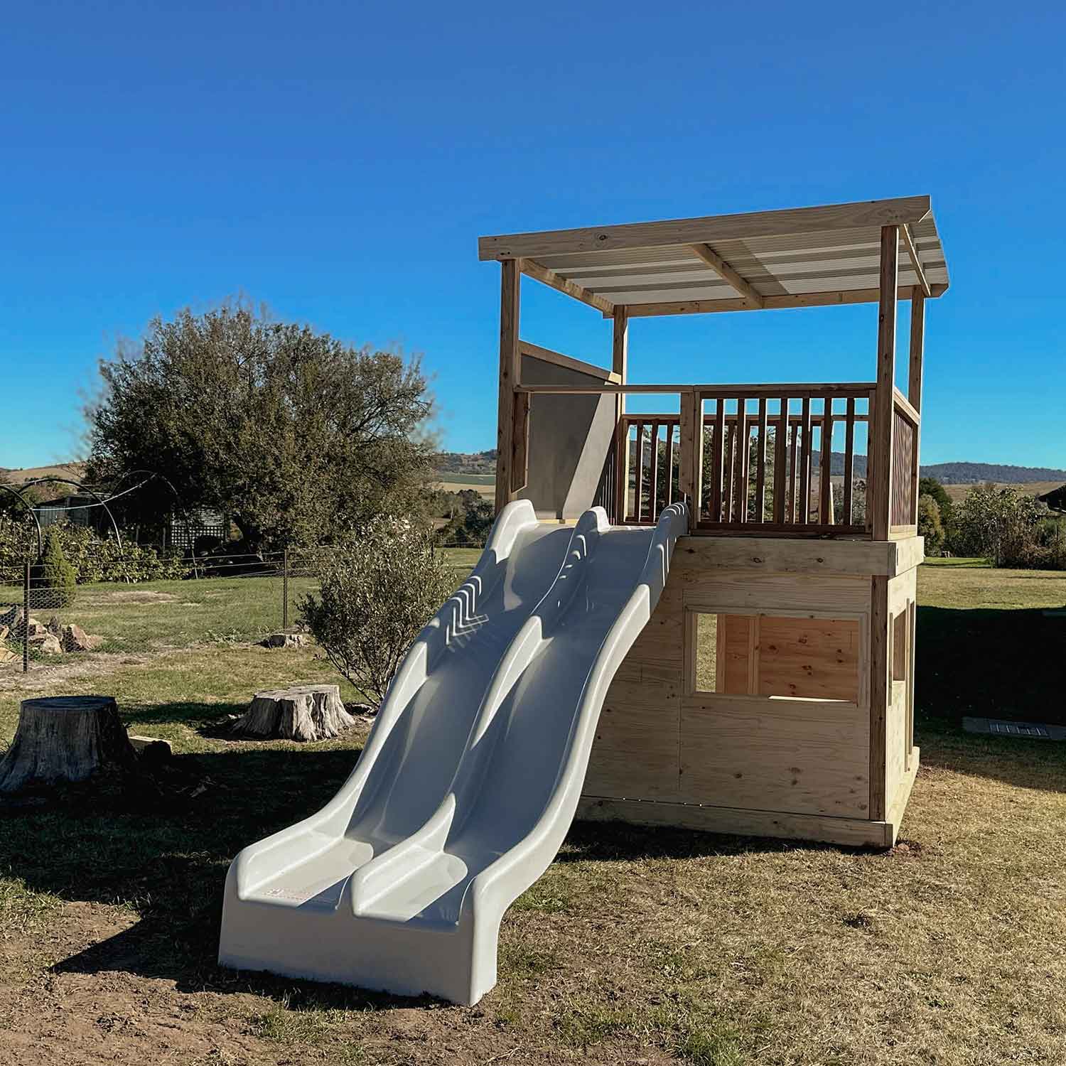 Timber Raised Platform Cubby House with Slide - For Primary Schools & Early Learning Centres - Hand Built in Australia by Castle & Cubby.