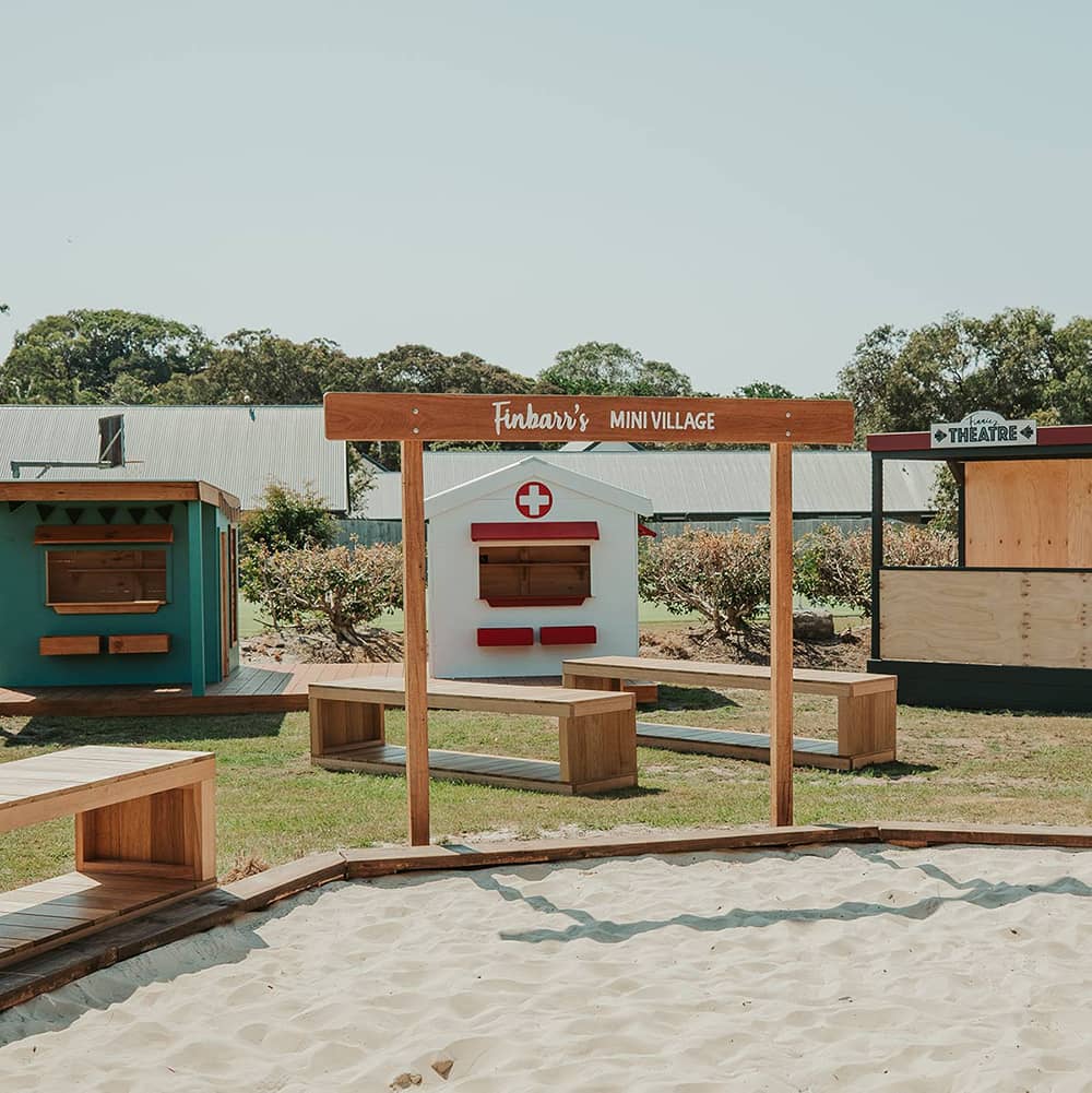 A mini village welcome entry sign in a school cubby play space